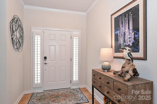 entrance foyer with ornamental molding, plenty of natural light, and light wood-type flooring