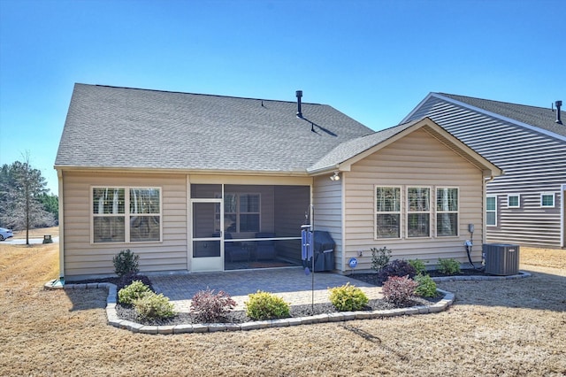 rear view of house featuring a patio, a sunroom, and central AC