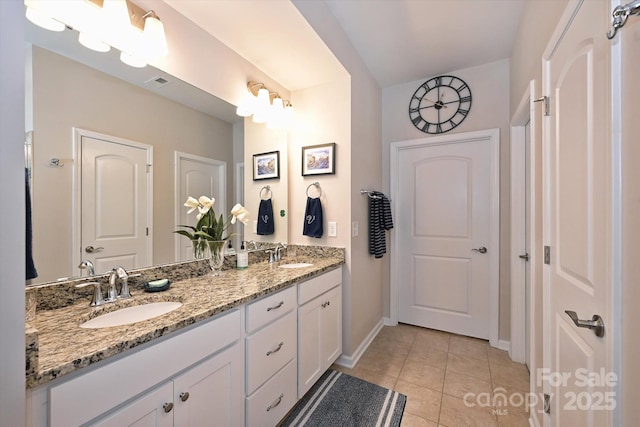 bathroom featuring tile patterned flooring and vanity