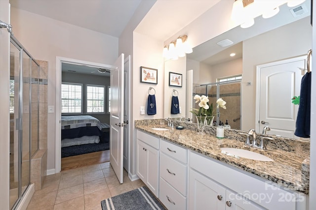 bathroom featuring vanity, an enclosed shower, and tile patterned flooring