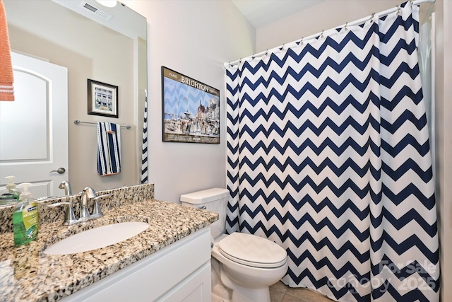 bathroom featuring a shower with curtain, vanity, toilet, and tile patterned flooring