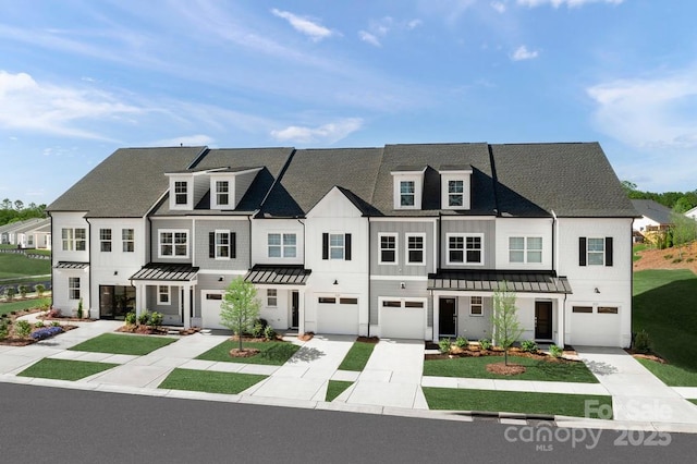 view of front of house with a garage, driveway, and a standing seam roof