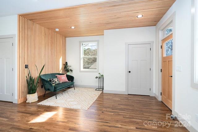 foyer entrance featuring dark hardwood / wood-style floors and wooden ceiling