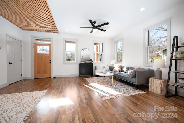 unfurnished living room with a wealth of natural light, ceiling fan, and wood-type flooring