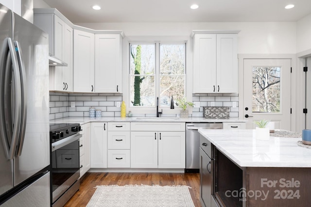 kitchen featuring white cabinets, appliances with stainless steel finishes, and dark hardwood / wood-style floors