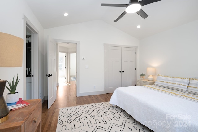 bedroom featuring ceiling fan, a closet, wood-type flooring, and vaulted ceiling