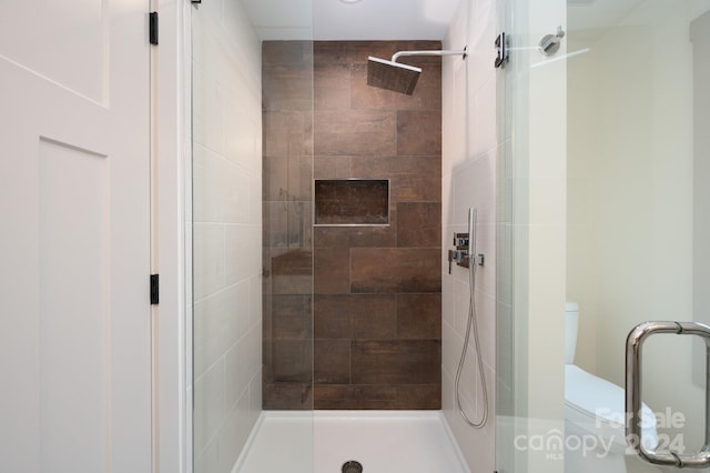 bathroom with walk in shower and toilet