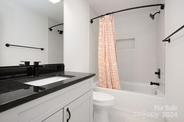 full bathroom with tile patterned flooring, shower / tub combo, vanity, and toilet