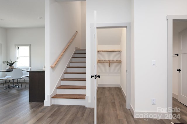 stairs featuring hardwood / wood-style floors