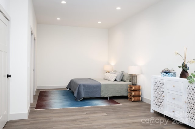 bedroom with light wood-type flooring and a closet