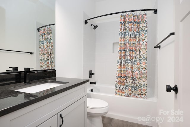 full bathroom with vanity, toilet, wood-type flooring, and shower / tub combo with curtain