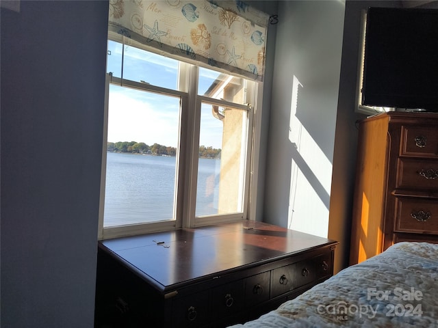 bedroom featuring a water view