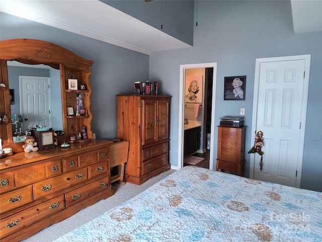 bedroom with connected bathroom and light colored carpet