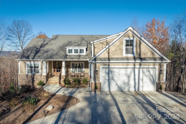 view of front of home with a porch and a garage