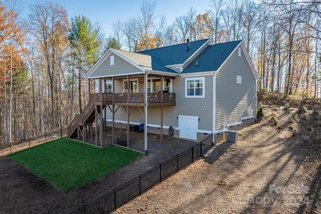 rear view of house featuring a yard and central air condition unit