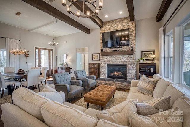 living room featuring beamed ceiling, a stone fireplace, and a towering ceiling