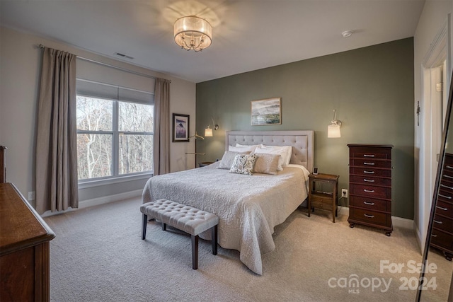 bedroom featuring light carpet