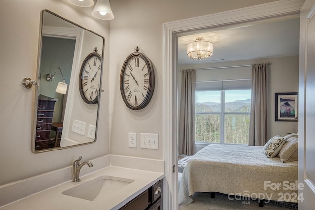 interior space with vanity, a mountain view, and a chandelier