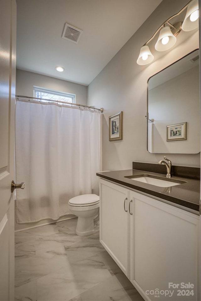 full bathroom with vanity, toilet, and shower / bath combo with shower curtain