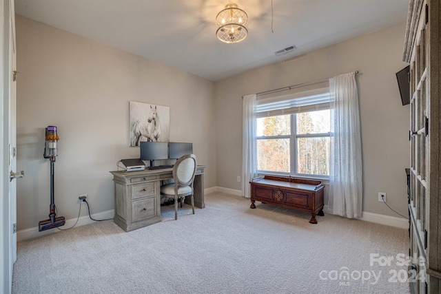 carpeted office space featuring a notable chandelier