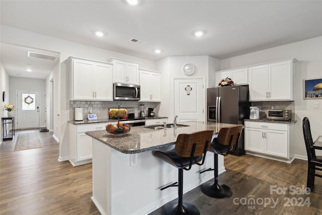 kitchen featuring sink, stainless steel appliances, dark hardwood / wood-style floors, an island with sink, and white cabinets