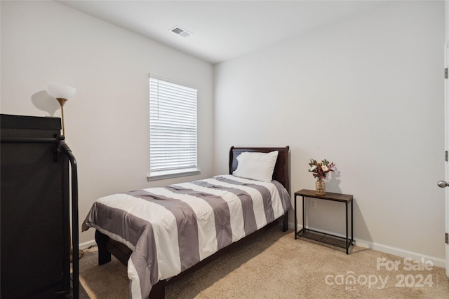 bedroom featuring light carpet