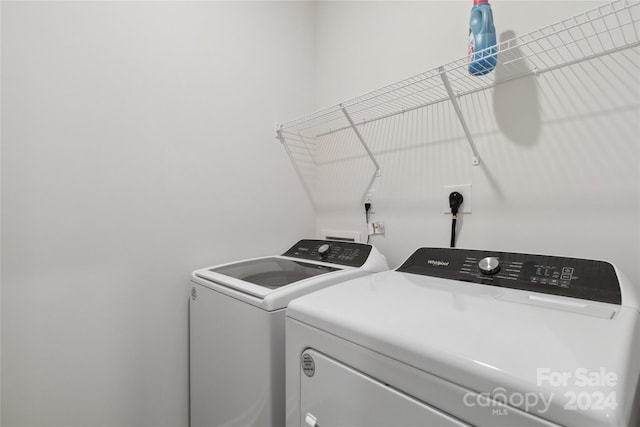 clothes washing area featuring washing machine and clothes dryer