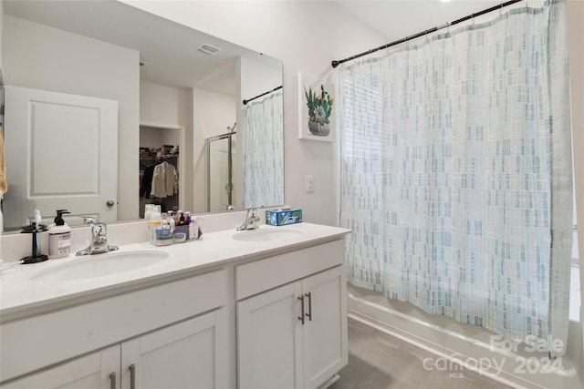 bathroom featuring vanity and shower / bathtub combination with curtain