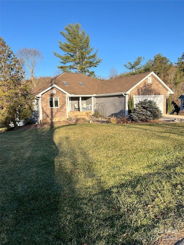 ranch-style home with a front lawn and a garage