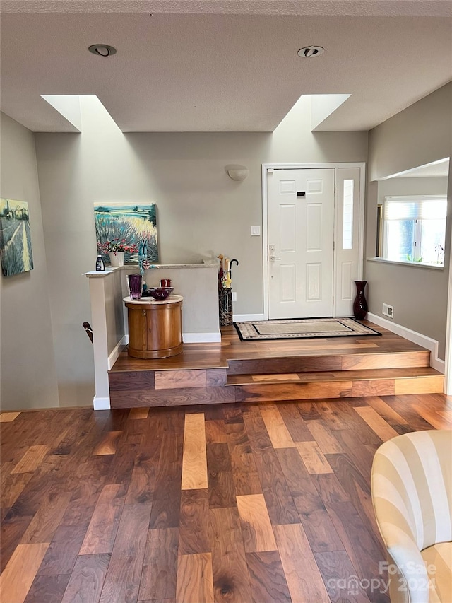 foyer entrance featuring wood-type flooring and a textured ceiling