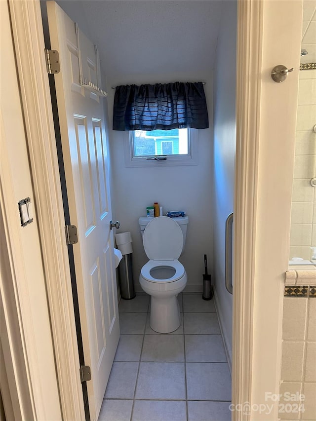 bathroom featuring tile patterned floors and toilet