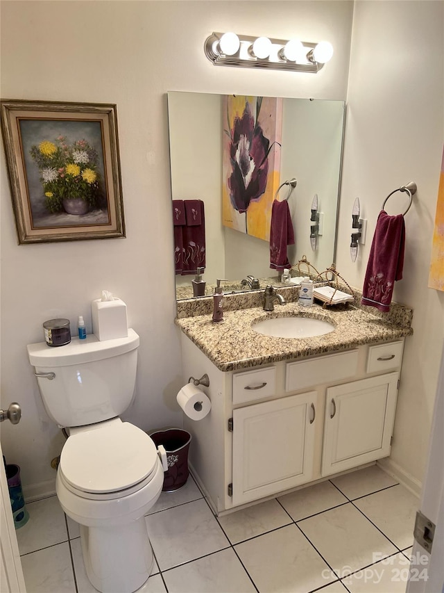 bathroom featuring tile patterned flooring, vanity, and toilet