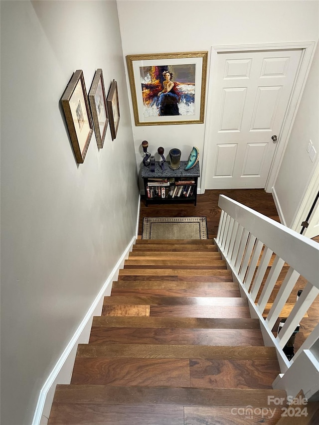 stairs featuring hardwood / wood-style flooring