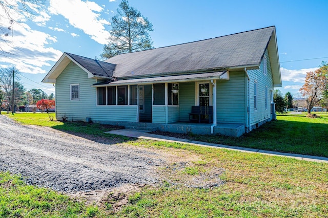 view of front of property with a porch and a front lawn