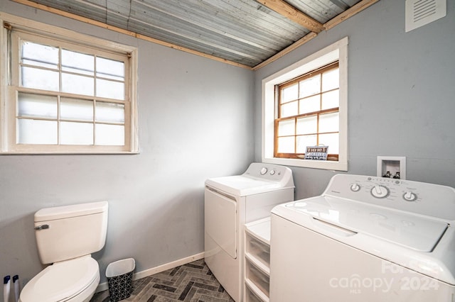 clothes washing area featuring separate washer and dryer, crown molding, and wood ceiling