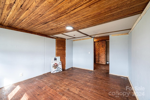 empty room with dark hardwood / wood-style floors and wooden ceiling