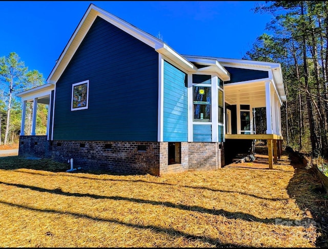 view of side of home featuring a porch