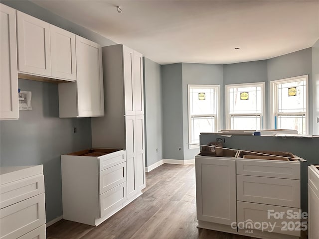 kitchen featuring light hardwood / wood-style flooring and white cabinets