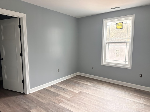 empty room with light hardwood / wood-style floors