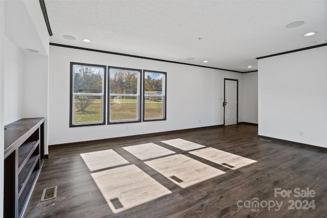 unfurnished living room featuring crown molding, dark hardwood / wood-style flooring, and a textured ceiling