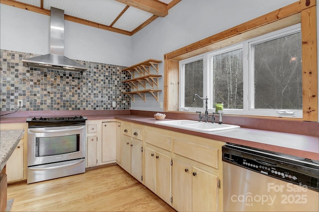 kitchen featuring sink, appliances with stainless steel finishes, backsplash, wall chimney exhaust hood, and light wood-type flooring