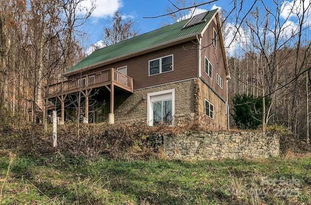 back of house featuring a wooden deck