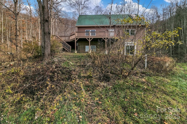 back of house featuring a wooden deck