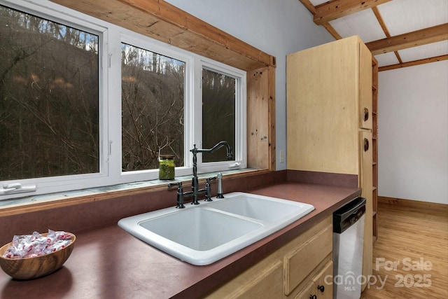 bathroom featuring sink, hardwood / wood-style flooring, and vaulted ceiling with beams