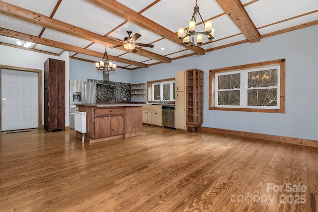 kitchen featuring hanging light fixtures, stainless steel appliances, and light wood-type flooring