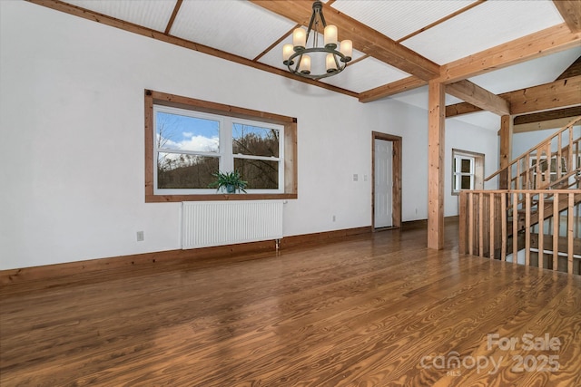 spare room with a notable chandelier, beam ceiling, radiator heating unit, and dark hardwood / wood-style floors