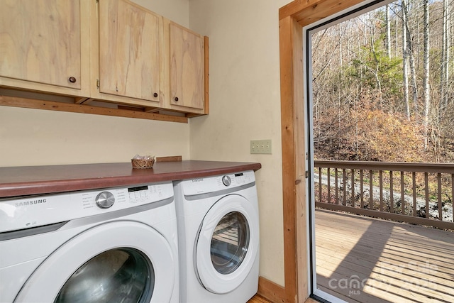 laundry room with cabinets and washer and dryer