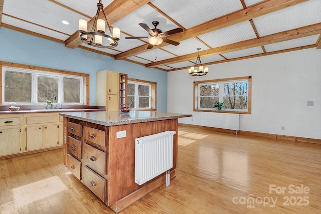278 Kelses Valley Dr, Mars Hill, NC 28754 - kitchen with a sink, baseboards, light wood-style floors, radiator heating unit, and a kitchen island