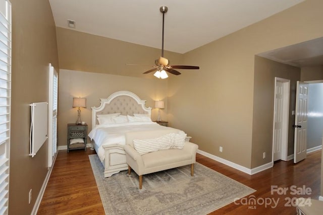 bedroom with ceiling fan and dark hardwood / wood-style floors