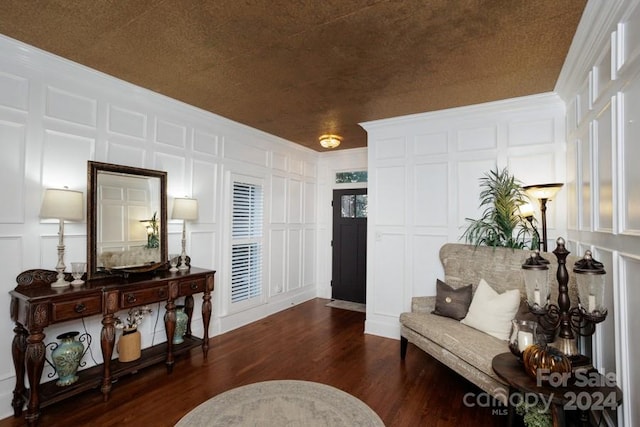 sitting room featuring dark hardwood / wood-style floors and crown molding